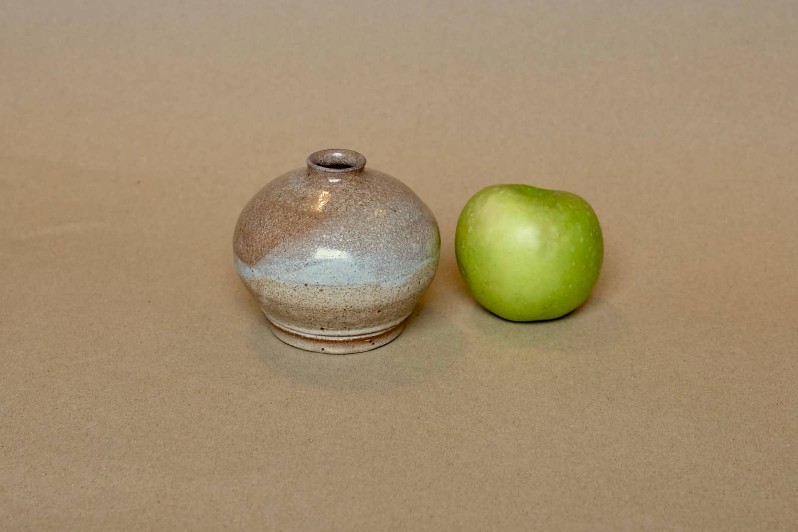 Bud vase with narrow neck and spherical body.