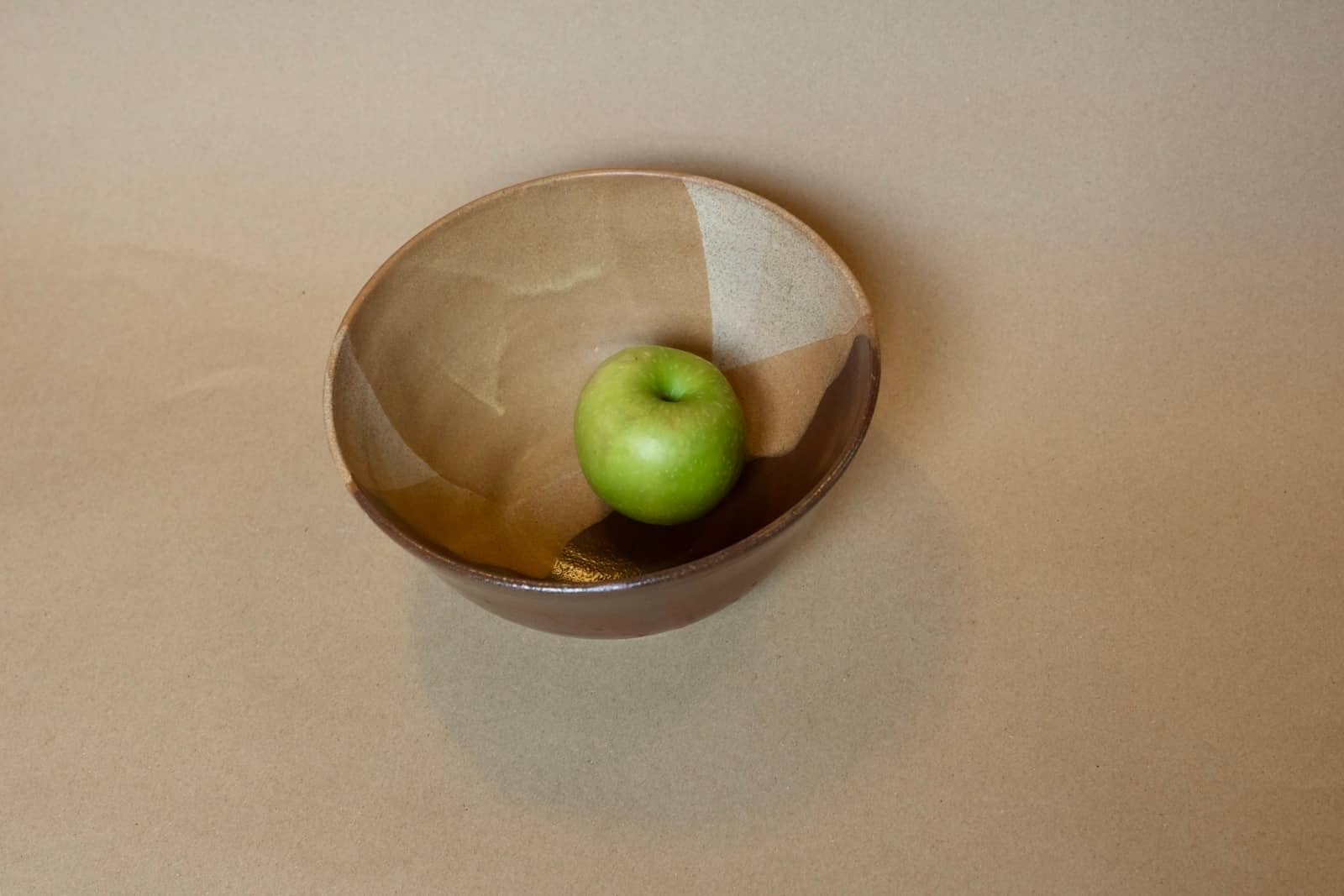Medium serving bowl with cream, white and chocolate brown glaze sections.