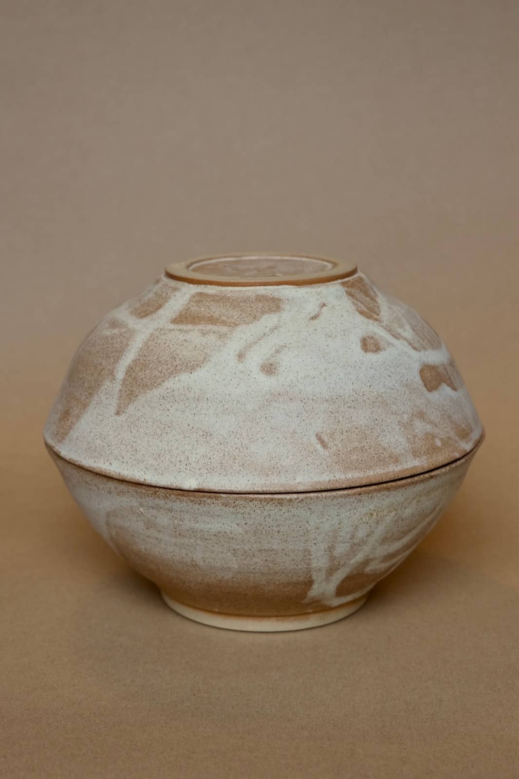 Pair of nesting bowls with organic marbled cream and brown glaze.