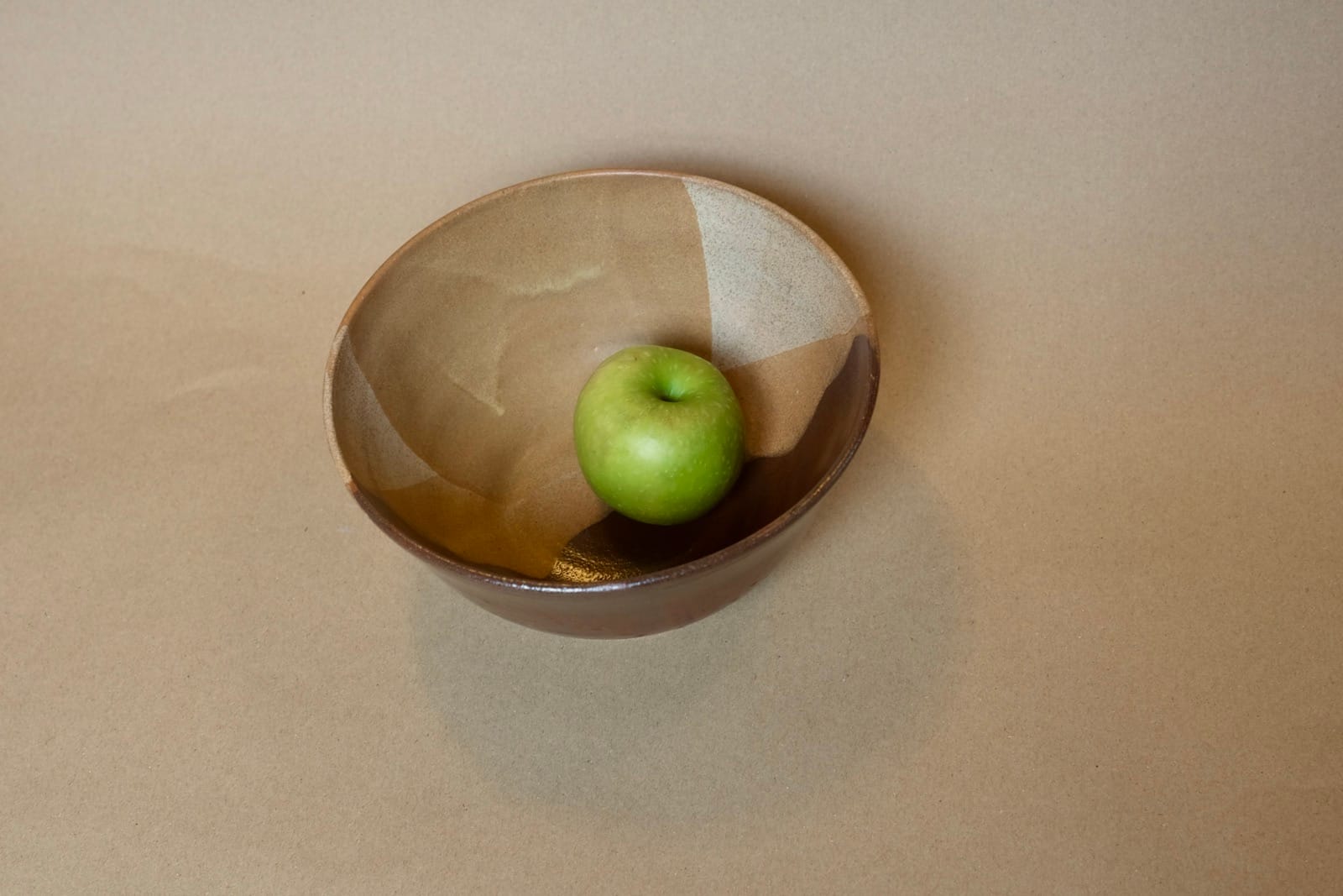 Medium serving bowl with cream, white and chocolate brown glaze sections.
