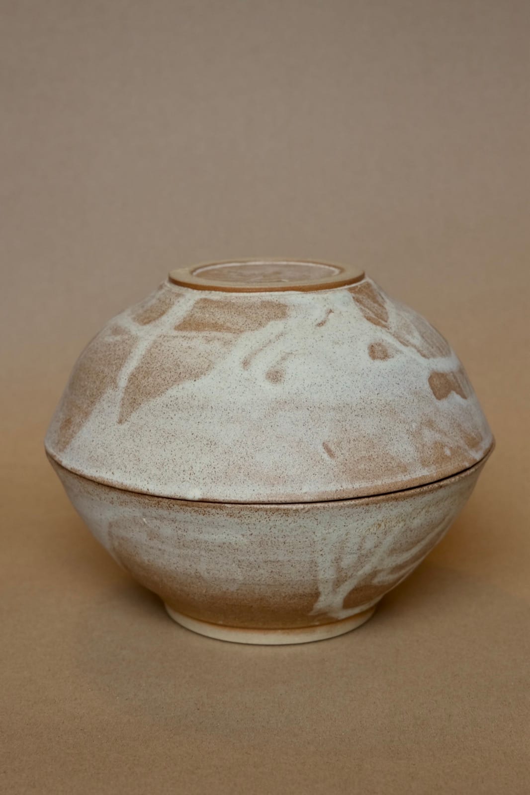 Pair of nesting bowls with organic marbled cream and brown glaze.
